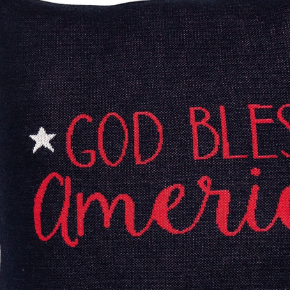 Black pillow with red and white text 'GOD BLESS AMERICA' on a dark background