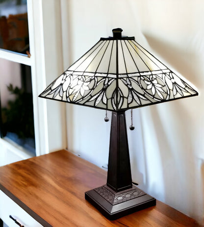 Decorative table lamp with stained glass shade on a wooden surface