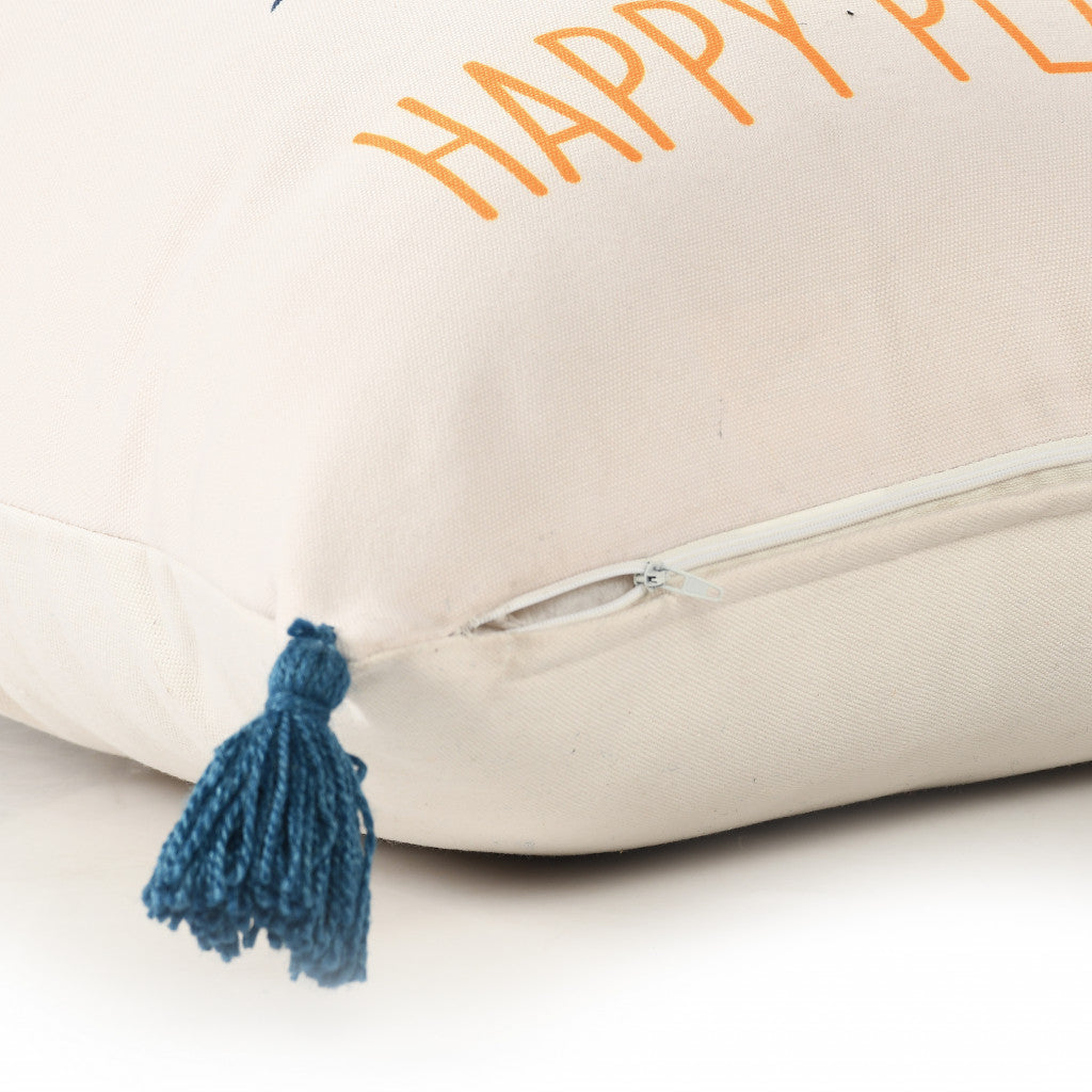 Beige pillow with 'Happy' text and blue tassel on a white background