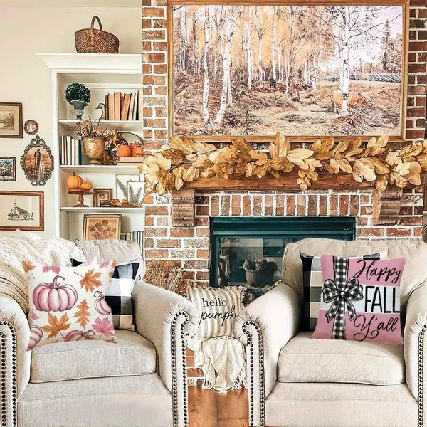 Living room with a fireplace, decorated for fall with pillows and a painting.