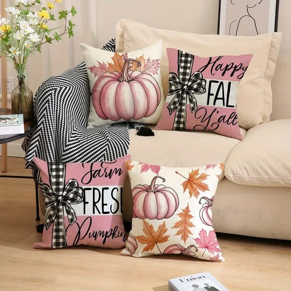 Decorative pillows with fall-themed designs on a couch