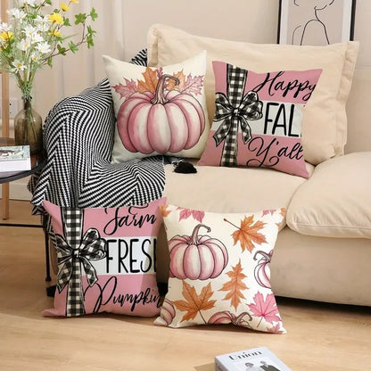 Decorative pillows with fall-themed designs on a couch