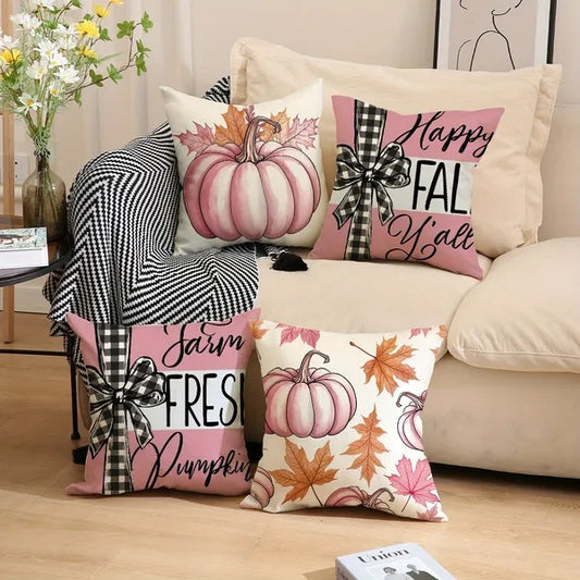 Decorative pillows with fall-themed designs on a couch