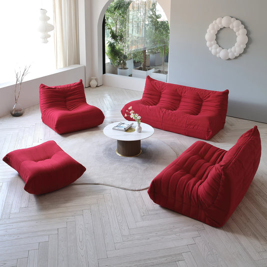 Red bean bag chairs in a modern living room with a coffee table.