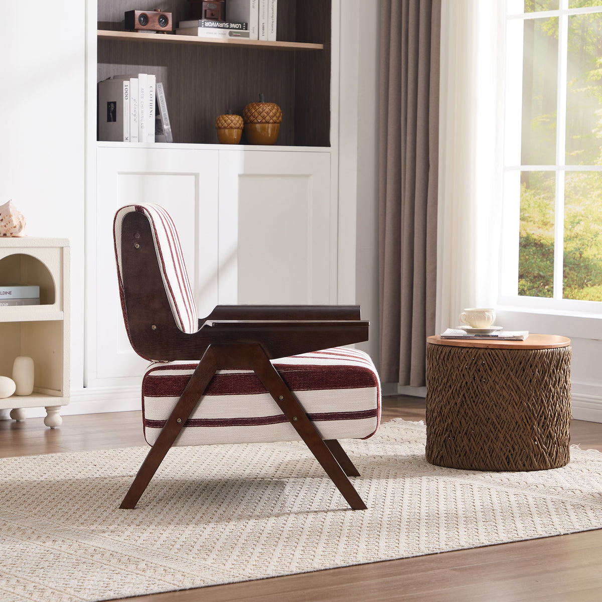Modern chair with striped cushion in a room with a bookshelf and window.