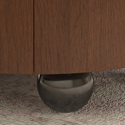 Close-up detail of a dark brown wood cabinet or dresser with a polished metallic ball support leg on a textured gray carpet.