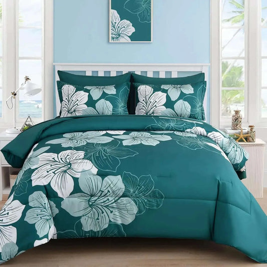 Teal floral bedding set in a bedroom with light blue walls and large windows.