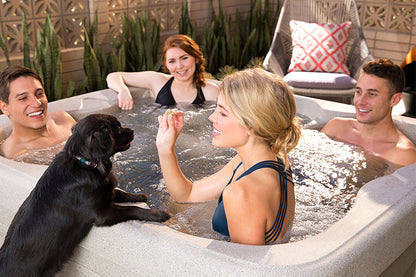 People in a hot tub with a dog