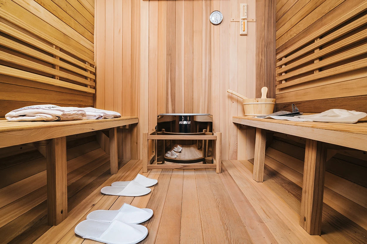Wooden sauna interior with benches, slippers, and a bowl. 4–6 Person Cedar Barrel Sauna Room with Porch – Outdoor Home Garden Sauna. 076823-f9.myshopify.com