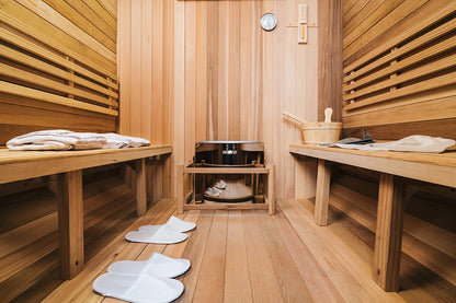 Wooden sauna interior with benches, slippers, and a bowl. 4–6 Person Cedar Barrel Sauna Room with Porch – Outdoor Home Garden Sauna. 076823-f9.myshopify.com