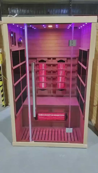 Infrared sauna with wooden exterior and glass door on a white 